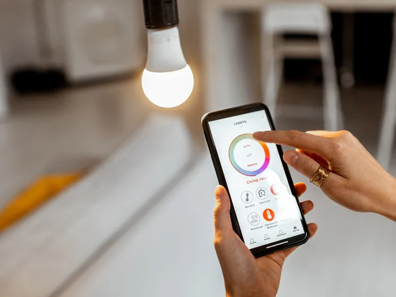 person-controlling-smart-led-light-bulb-with-smartphone